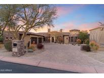 Stunning desert home featuring a brick driveway, lush landscaping, and a private two-car garage at 15956 E Tombstone Trl, Fountain Hills, AZ 85268