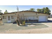 Charming single-story home with desert landscaping and attached one car garage at 1630 S Sossaman Rd, Mesa, AZ 85209