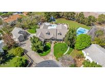 Expansive home featuring an in-ground pool, tennis court, trampoline, large yard, and mature trees at 1632 S Alba Cir, Mesa, AZ 85204