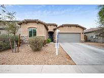 Charming single-story home with desert landscaping, neutral stucco, stone accents, and attached two-car garage at 17545 W Lilac St, Goodyear, AZ 85338