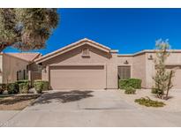 Charming single-story home featuring a tile roof, two-car garage, and low-maintenance landscaping at 2348 W Comstock Dr, Chandler, AZ 85224