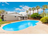 Backyard pool view features a pool, patio, palm trees, and the exterior of the home at 2356 W Catalina Ave, Mesa, AZ 85202