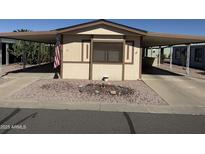 Charming home featuring a covered carport, rock landscaping, and neutral colored exterior at 3330 E Main St # 332, Mesa, AZ 85213