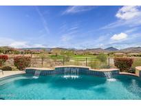 Beautiful pool with water features overlooks golf course and mountain views at 41819 N Anthem Ridge Dr, Phoenix, AZ 85086