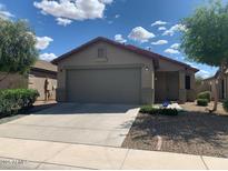 Charming single-story home features a two-car garage, desert landscaping, and a cozy front porch at 42371 W Sunland Dr, Maricopa, AZ 85138