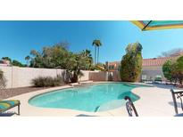 Lovely pool area featuring lush landscaping, a rock waterfall, and a serene atmosphere at 6720 W Mcrae Way, Glendale, AZ 85308