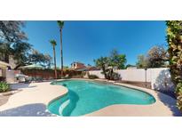 Beautiful backyard pool with lush landscaping, perfect for cooling off on hot summer days at 6720 W Mcrae Way, Glendale, AZ 85308