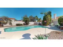 Backyard features a spacious swimming pool and deck area, great for entertaining guests at 6720 W Mcrae Way, Glendale, AZ 85308