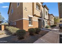 Two-story condo showcases neutral toned stucco and neatly trimmed landscaping; numbered '16' is visible at 7726 E Baseline Rd # 156, Mesa, AZ 85209