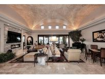 Elegant living room featuring a unique brick ceiling, fireplace, and ample seating at 8406 E Calle Buena Vis, Scottsdale, AZ 85255