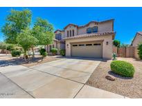 Charming two-story home featuring a well-manicured front yard, a driveway, and an attached two-car garage at 11219 N 165Th Ave, Surprise, AZ 85388