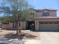Charming two-story home featuring a well-maintained front yard and neutral stucco at 11219 N 165Th Ave, Surprise, AZ 85388