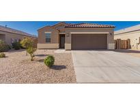 Charming single-story home with a well-maintained yard and two-car garage, perfect for comfortable living at 1178 E Tyler Ln, Casa Grande, AZ 85122