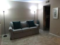 Cozy living room with a comfortable couch and elegant floor lamps at 12123 W Bell Rd # 118, Surprise, AZ 85378
