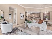 Bright and airy living room connecting to the kitchen and featuring neutral tones at 12625 N Saguaro Blvd # 203, Fountain Hills, AZ 85268