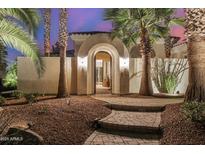 Stunning front entrance with arched doorway, desert landscaping, and brick pathway at 13207 W Santa Ynez Dr, Sun City West, AZ 85375