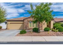 Charming single-Gathering home featuring desert landscaping and a mix of stone and stucco exterior at 14906 W Luna N Dr, Litchfield Park, AZ 85340
