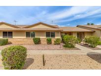 Charming single-story home with neutral tones, well-manicured landscaping, and a welcoming walkway at 18861 N Palomar Dr, Sun City West, AZ 85375