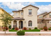 Charming two-story home with a well-manicured front yard, covered porch and desert landscaping at 2571 S Melvin St, Gilbert, AZ 85295