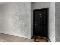 A solid black front door with the number 108 in a tan stucco entryway, welcoming visitors at 3302 N 7Th St # 108, Phoenix, AZ 85014