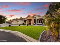 Charming single-story home with lush green lawn, brick accents, and a three-car garage, perfect for Gathering living at 5670 W Linda Ln, Chandler, AZ 85226