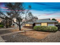 Charming single-story home showcasing desert landscaping, a brick walkway, and a well-maintained facade at 6938 E Flossmoor Ave, Mesa, AZ 85208