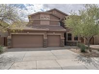Inviting two-story home features a three-car garage, desert landscaping, and neutral-toned exterior at 8339 W Molly Ln, Peoria, AZ 85383