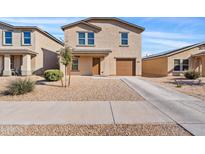 Charming two-story home featuring a well-maintained yard and a welcoming front entrance at 148 E Douglas Ave, Coolidge, AZ 85128