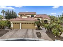 Charming two-story home featuring a three-car garage, landscaped front yard, and tiled roof at 15948 W Sheila Ln, Goodyear, AZ 85395
