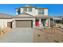 Charming two-story home featuring a red door, neutral color scheme, and low maintenance front yard landscaping at 17642 W Sanna St, Waddell, AZ 85355