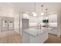Stylish kitchen with white cabinets, quartz countertops, and stainless steel appliances at 2416 S Evergreen Rd, Tempe, AZ 85282