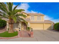 Inviting two-story home featuring an attached garage, red brick walkway, and a lush green palm tree at 25425 N 64Th Ave, Phoenix, AZ 85083