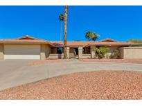 Charming single-story home with a well-maintained yard, mature trees, and a two-car garage at 302 E Carol Ann Way, Phoenix, AZ 85022