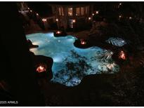 Inviting community pool featuring rockwork accents and cozy fire pits for evening relaxation at 5450 E Deer Valley Dr # 4018, Phoenix, AZ 85054