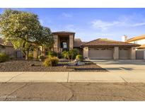 Charming home featuring well-maintained landscaping, three car garage, and a lovely desert yard at 76 W Stacey Ln, Tempe, AZ 85284