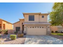 Two-story home featuring a two-car garage, neutral color scheme and low maintenance landscaping at 8637 W Kathleen Rd, Peoria, AZ 85382