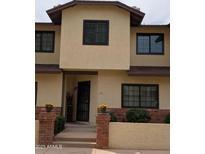 Charming two-story townhouse featuring neutral stucco and black window accents at 170 E Guadalupe Rd # 154, Gilbert, AZ 85234