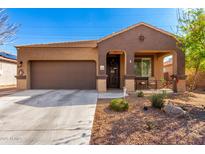 Charming home with a welcoming front porch and desert landscaping at 23791 W Magnolia Dr, Buckeye, AZ 85326