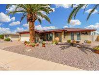 Charming brick home featuring desert landscaping, a paved driveway, and a prominent palm tree in the front yard at 4838 E Calypso Ave, Mesa, AZ 85206