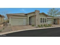 Charming single-story home featuring a two-car garage and a meticulously landscaped front yard at 5195 N 207Th Dr, Buckeye, AZ 85396
