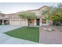 Charming two-story home with a three-car garage, artificial turf lawn, and desert landscaping in a desirable neighborhood at 7456 W Honeysuckle Dr, Peoria, AZ 85383