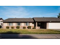Charming single-story home with a well-manicured lawn, symmetrical design and an attached two-car garage at 13219 N 46Th Pl, Phoenix, AZ 85032