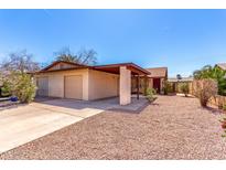 Charming single-story home with a covered parking area and low-maintenance desert landscaping at 1531 E El Parque Dr, Tempe, AZ 85282