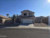 Charming home featuring well-maintained landscaping, a two-car garage, and a welcoming entrance at 16317 N 152 Ave, Surprise, AZ 85374