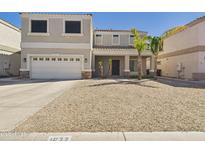 Charming two-story home featuring a two-car garage and drought-tolerant landscaping at 1677 E Heather Dr, San Tan Valley, AZ 85140