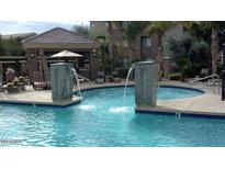 A community pool with water features and nearby seating area at 18416 N Cave Creek Rd # 1053, Phoenix, AZ 85032