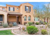 Charming two-story home showcasing a tile roof, desert landscaping and stucco exterior at 18552 N 94Th St, Scottsdale, AZ 85255