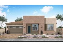 A modern desert home boasts a clean stucco facade, an attached two car garage, and desert landscaping at 2516 E Tepenade Dr, San Tan Valley, AZ 85140