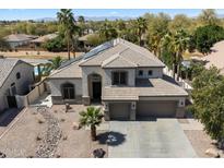 Stunning two-story home featuring desert landscaping, a three-car garage, and solar panels at 2702 S Beverly Pl, Chandler, AZ 85286