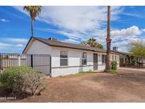 Charming single-story home with freshly painted exterior and desert landscaping at 7492 W Desert Cove Ave, Peoria, AZ 85345